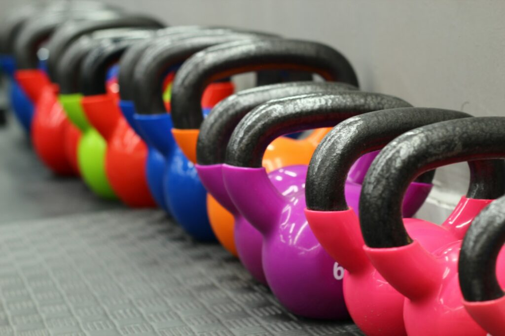 a row of kettles lined up against a wall